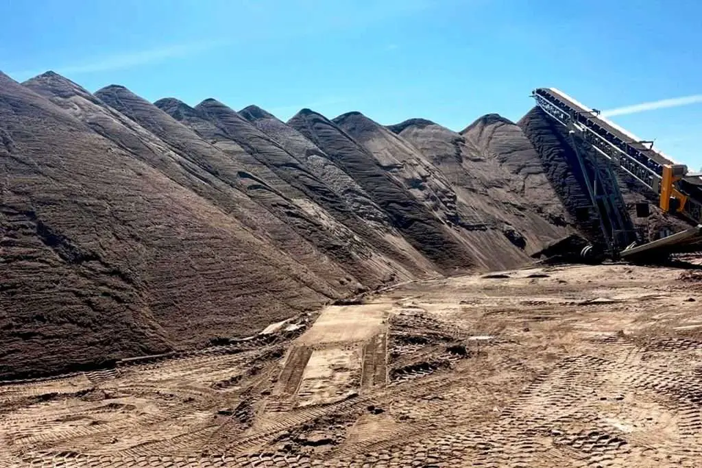 Sand and gravel pit with piles of aggregate